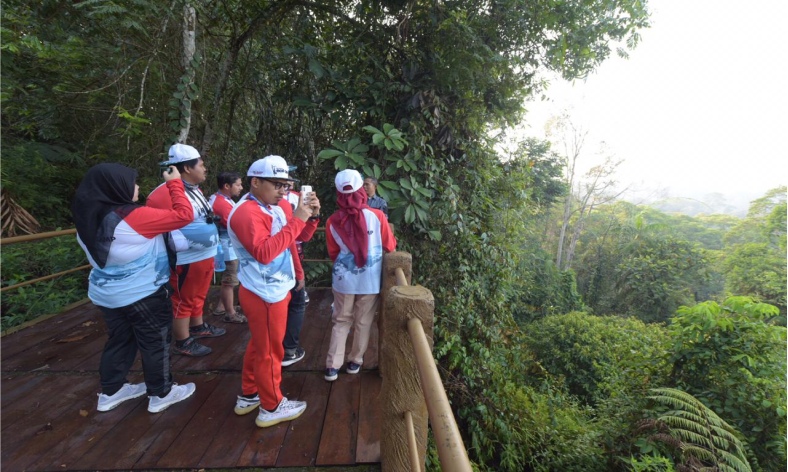 Participants of Pertamina Eco Camp 2019 crossed a track at the Bodogol Nature Conservation Education Center (or PPKAB) at the Gede Pangrango National Park in West Java Province on Tuesday